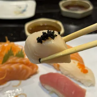 chopsticks holding a piece of sushi