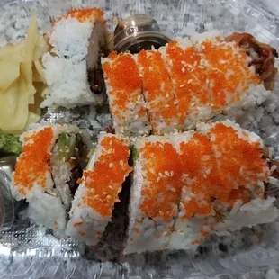 a plastic container filled with sushi