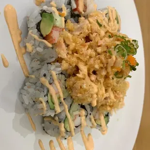 a plate of sushi with sauce