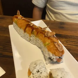 a long roll of sushi on a plate