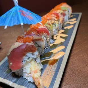 a sushi roll with a blue umbrella