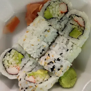 a plate of sushi and rolls