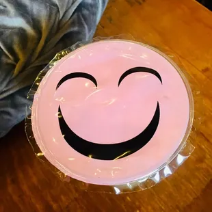 a pink plate with a smiley face on it