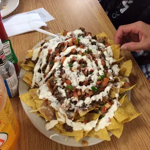 now that is what you call a good and yummy SUPER NACHO! 2.. maybe 3x the size of my head!