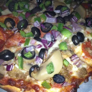 a pizza with olives and peppers