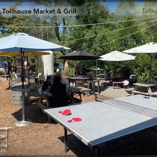 Outside seating complete with ping pong and corn hole.