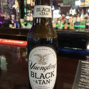 a bottle of black and tan beer