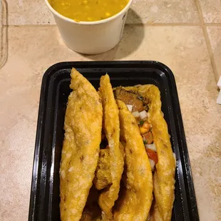  a bowl of soup and a plate of fried fish