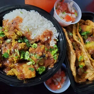  a bowl of rice and a bowl of meat and vegetables