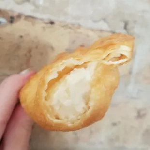 a hand holding a pastry