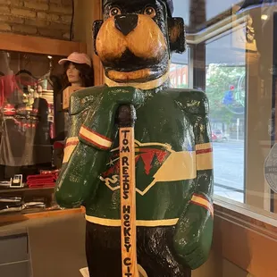 a bear with a hockey stick