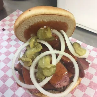 a hot dog with onions and pickles