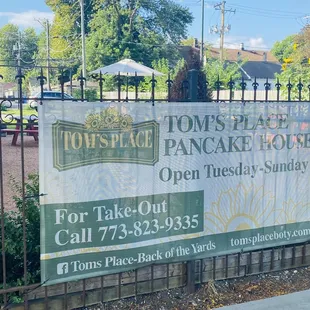 Banner to advertise the restaurant on the fence of the enclosed patio.