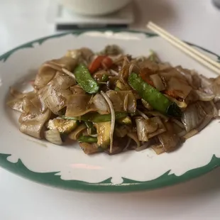 a plate of food with chopsticks