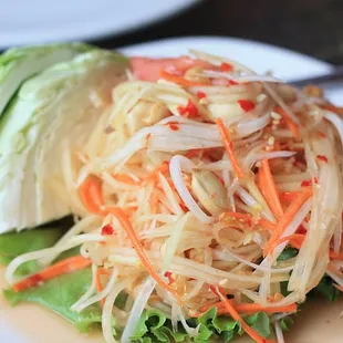 Papaya Salad Extra Hot, Shredded green papaya topped with garlic, lime juice and chili pepper