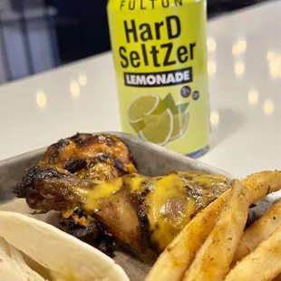 a plate of food and a can of lemonade