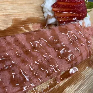 Strawberry tamale topped with strawberry jam, whipped cream and strawberry