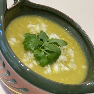 a bowl of soup with a garnish of cilantro