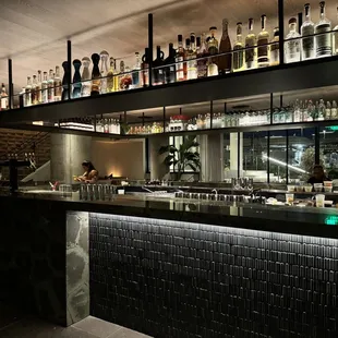 a bar with bottles on the shelves