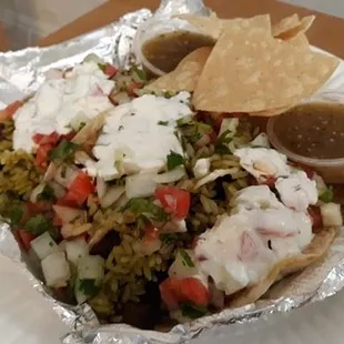Three steak tacos with cilantro rice,sour cream, roasted corn salsa on flour tortillas