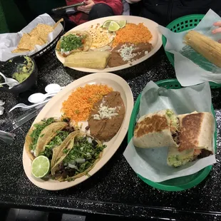 Steak Burrito, guacamole and chips, tomatillo plate, 3 taco dinner plate, and extra tamale!!!