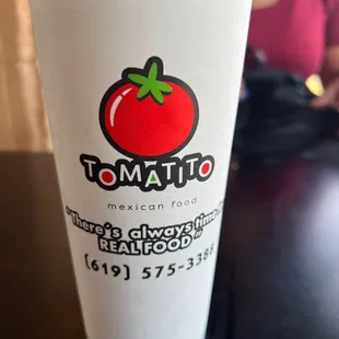 a plastic cup with a tomato on it