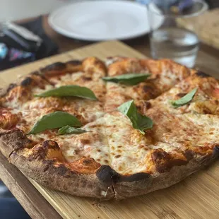 a pizza on a cutting board