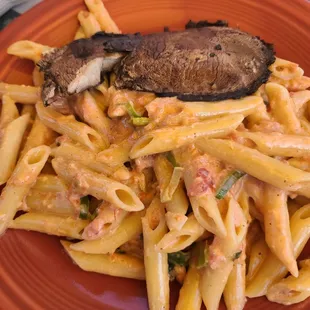 Pink leek pasta with a portobello mushroom on top