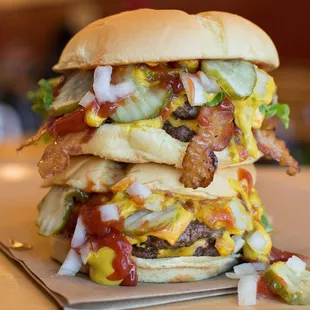 a stack of hamburgers on a table