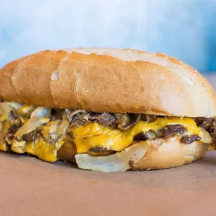 a cheeseburger with onions and cheese