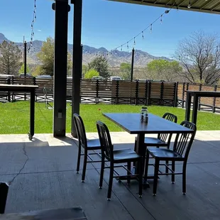 a patio with tables and chairs
