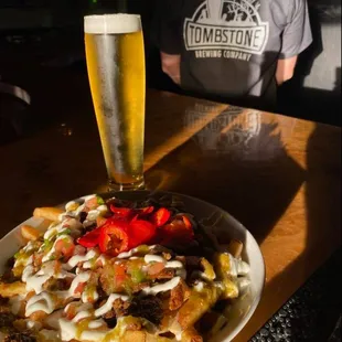 a plate of fries and a glass of beer