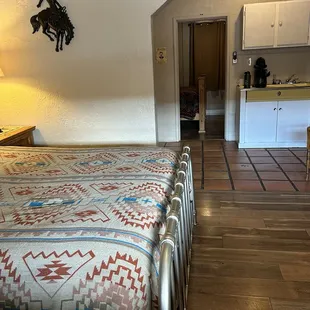 View from the front door, showing you the main room and peering into the bedroom