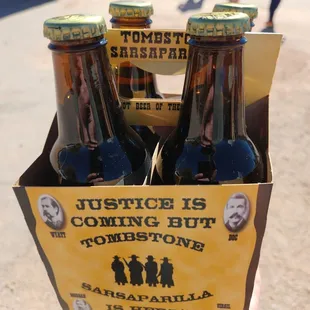 a person holding a box of beer