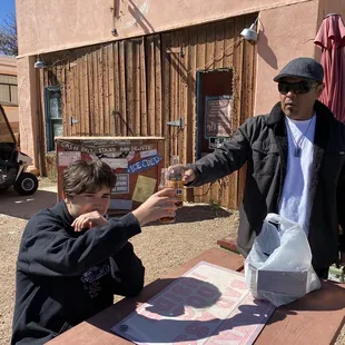 a man and a boy at a picnic table