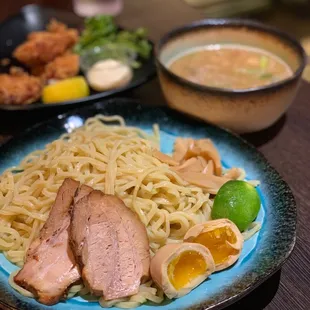a plate of ramen and a bowl of soup