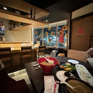 a table with a bowl of ramen and a bowl of soup