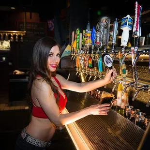 a woman standing behind a bar
