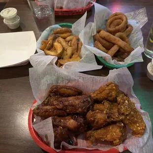 Honey BBQ and Buffalo Sings the Bleus. Potato wedges and onion rings