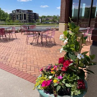 a patio with tables and chairs