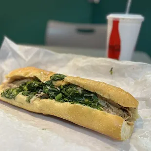 a sub sandwich with spinach