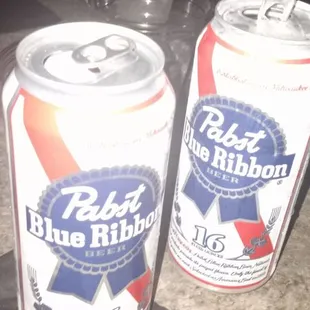 two cans of beer on a table