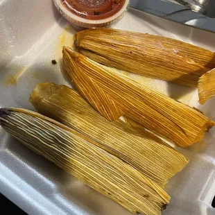 a plate of tamales and a fork