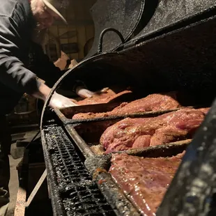 a man cooking meat