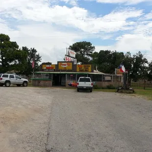 two cars parked in front of a restaurant