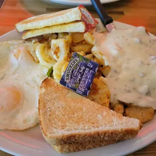 Chicken fried steak, smothered in country gravy of course.  Eggs over easy, and country potatoes.