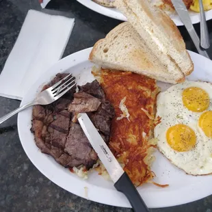 The piece of paper is on top of the knife. It was cooked with my steak. ‍