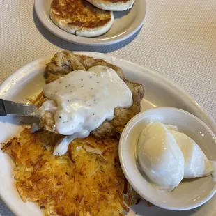 Chicken fried steak ,hashbrowns and poached eggs and English muffin.