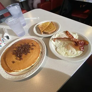 Chocolate chip pancakes with toast, eggs, &amp; bacon