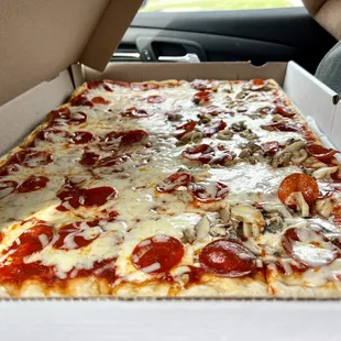 Tray with pepperoni and half with also mushrooms